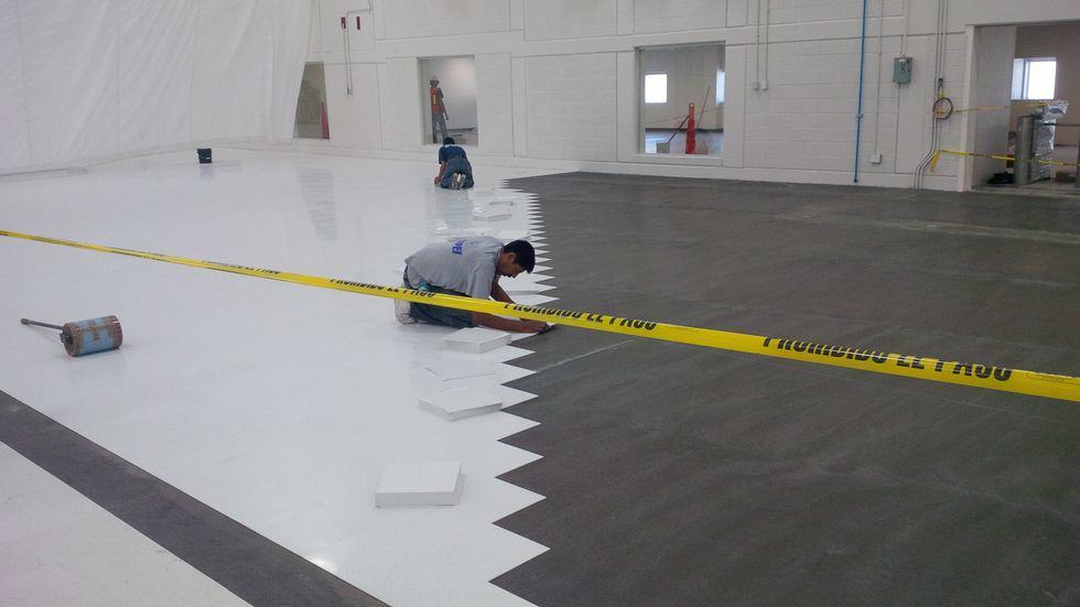 Flooring installer laying Ameriworx ESD vinyl.