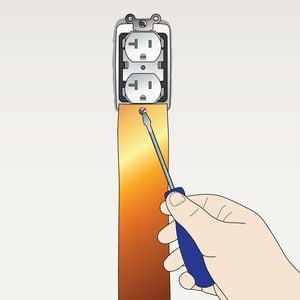 Illustration of a hand securing a copper strap to an AC electrical outlet with a screw.