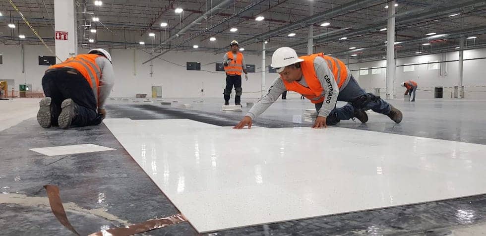 Image shows an in progress installation of AmeriWorx ESD solid vinyl, being laid over conductive adhesive