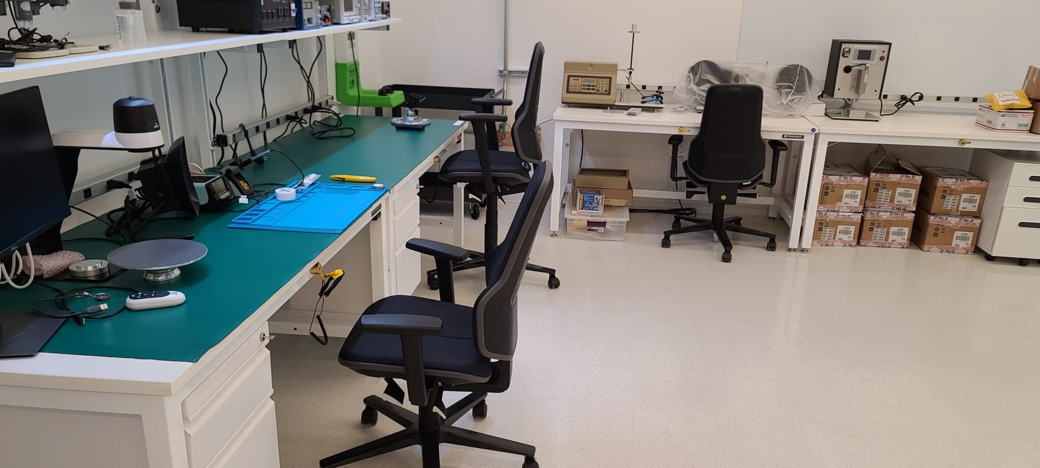 Photo of a laboratory with ESD flooring with some ESD chairs under the tables.
