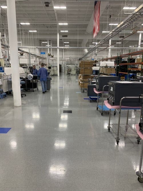 A completed installation of AmeriWorx conductive (ESD) vinyl tile flooring in an electronics manufacturing facility