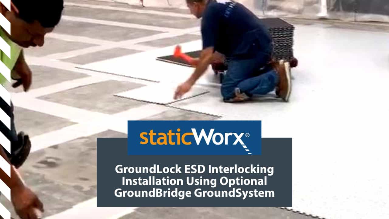Background image is an photo of contractors installing GroundLock ESD interlocking tile over GroundBridge underlayment. In the foreground at the bottom are two boxes. The top is a bright blue with the StaticWorx logo. The second is a dark blue-gray and includes the text in white: “GroundLock ESD Interlocking Installation Using GroundBridge GroundSystem"