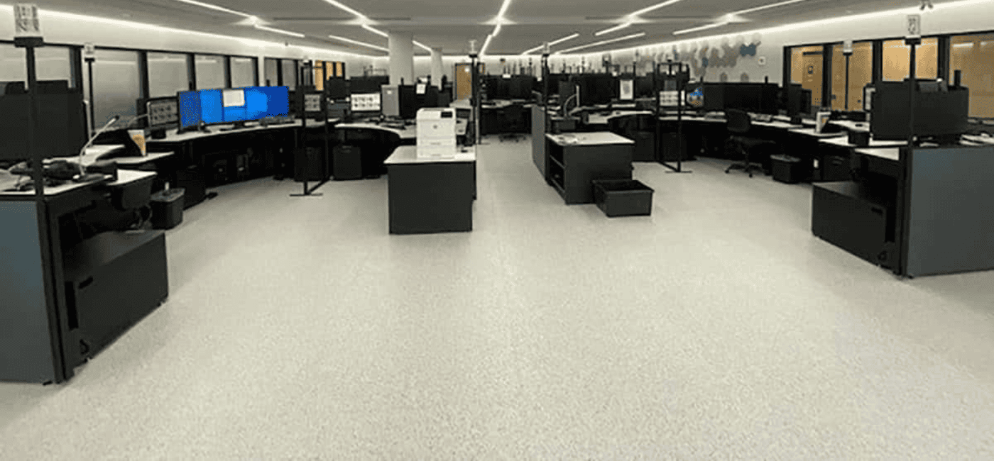 Completed installation of GroundLock Extreme ESD interlocking tile at Peel Regional Police Department. The space is filled with desks and equipment.