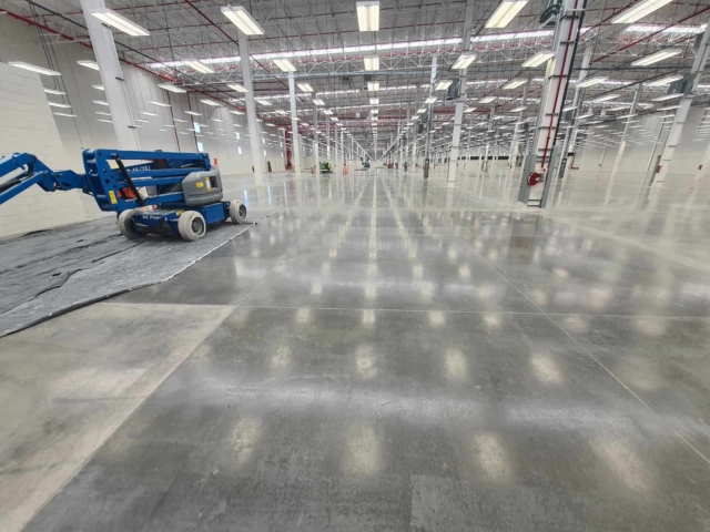 A genie overhead boom in a large open space being prepared for an ESD flooring installation