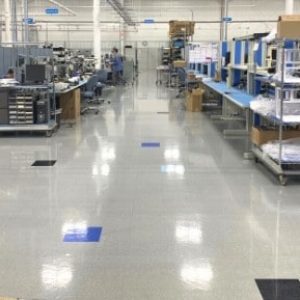 A completed installation of AmeriWorx conductive (ESD) vinyl tile flooring in an electronics manufacturing facility