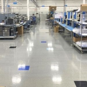 A completed installation of AmeriWorx conductive (ESD) vinyl tile flooring in an electronics manufacturing facility